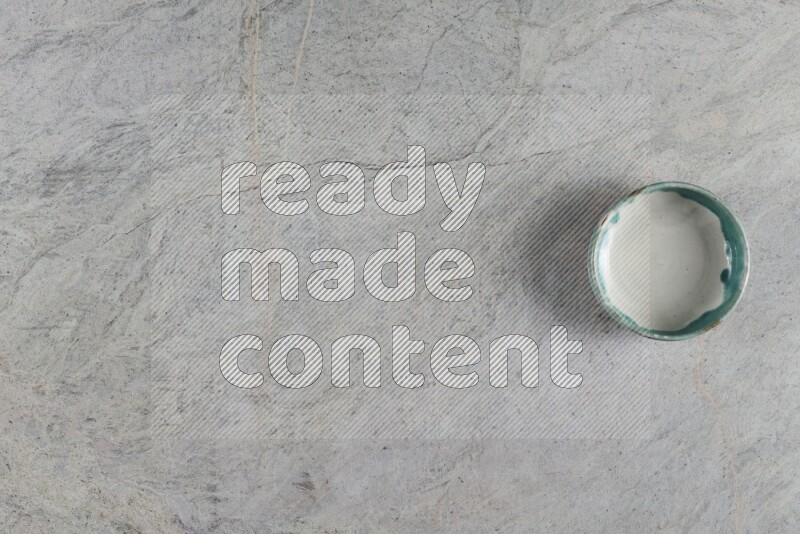 A multicolored pottery Bowl on grey marble background