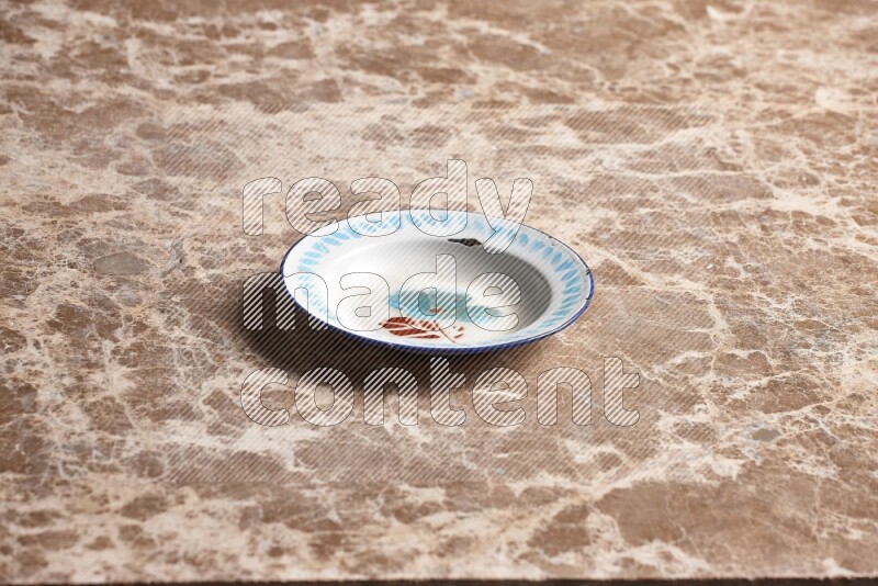 A vintage metal plate on beige marble background