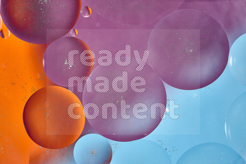 Close-ups of abstract oil bubbles on water surface in shades of blue, orange and purple