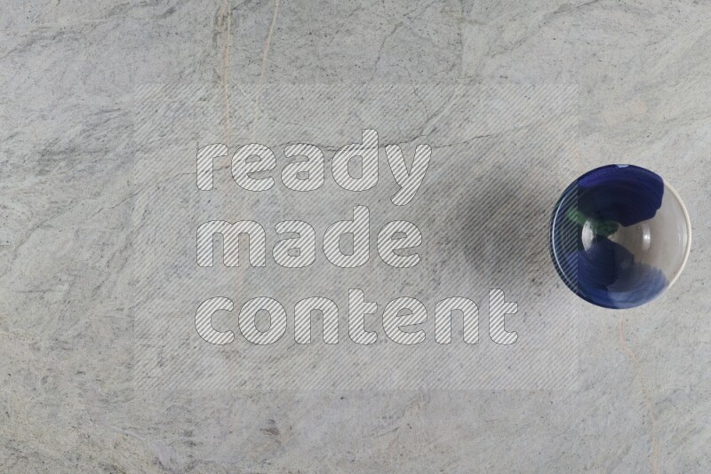 A multicolored pottery Bowl on grey marble background
