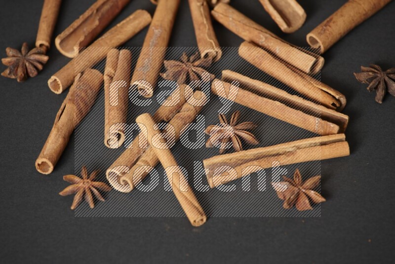Cinnamon sticks and star anise on black background