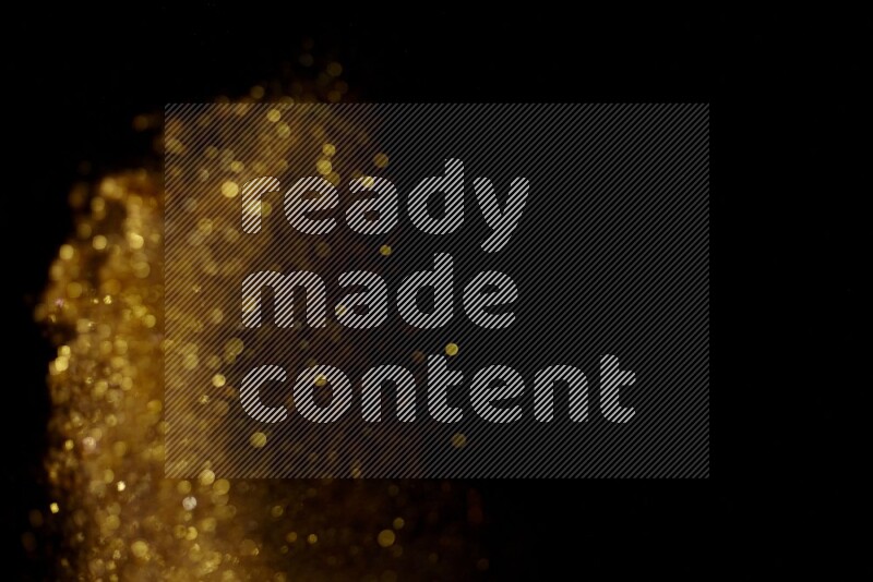 Gold glitter powder isolated on black background