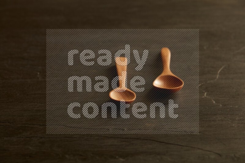 wooden spoon on black slate background