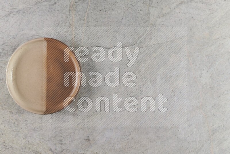 A multicolored pottery oven bowl on grey marble background