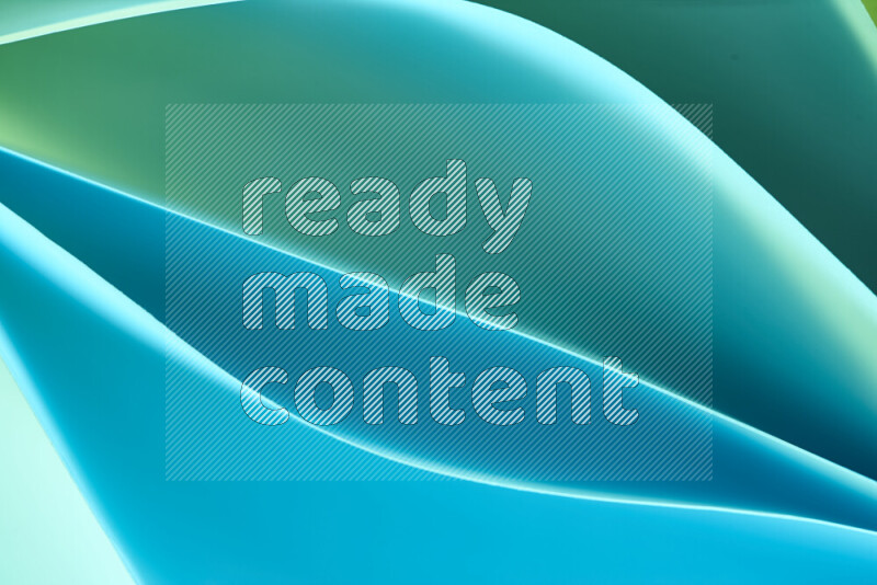 This image showcases an abstract paper art composition with paper curves in green and blue gradients created by colored light