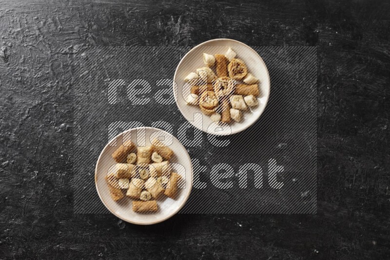 Oriental sweets in pottery plates in a dark setup