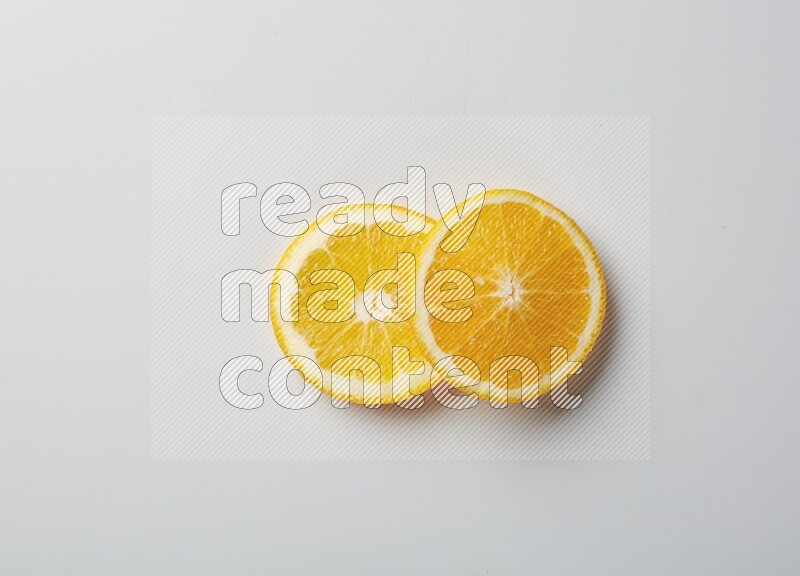 Two orange slices on white background
