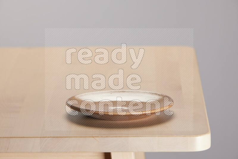 multi-colored pottery Plate on a wooden table edge