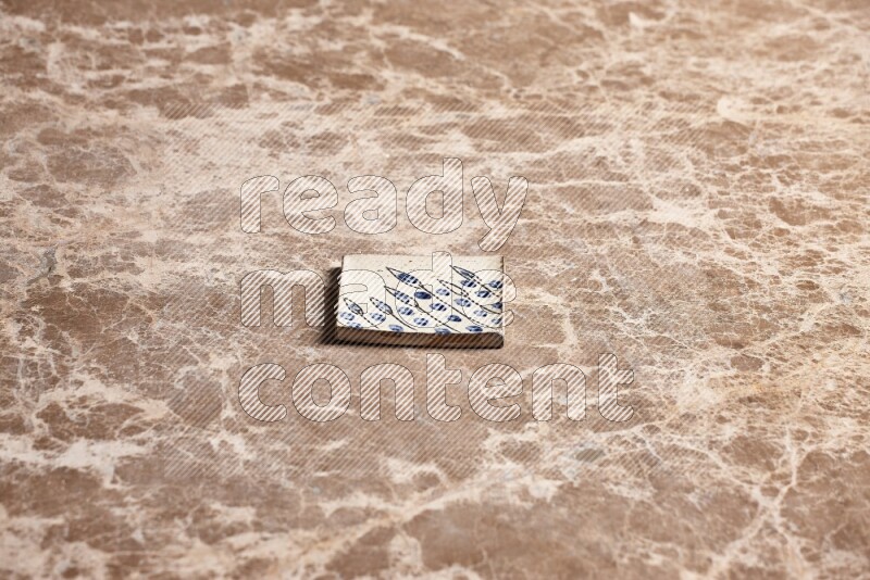 A decorative coaster on beige marble background