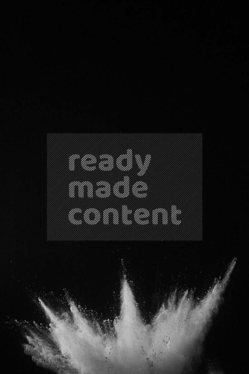 A side view of white powder explosion on black background