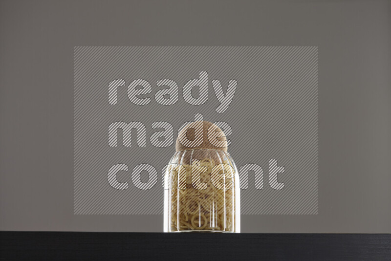 Snacks in a glass jar on black background