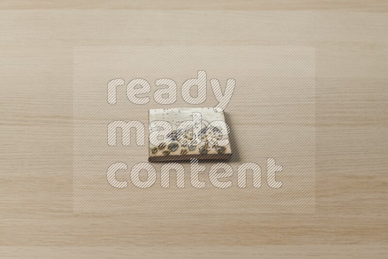 A decorative coaster on light wooden background