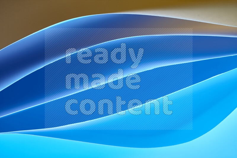 This image showcases an abstract paper art composition with paper curves in blue and orange gradients created by colored light