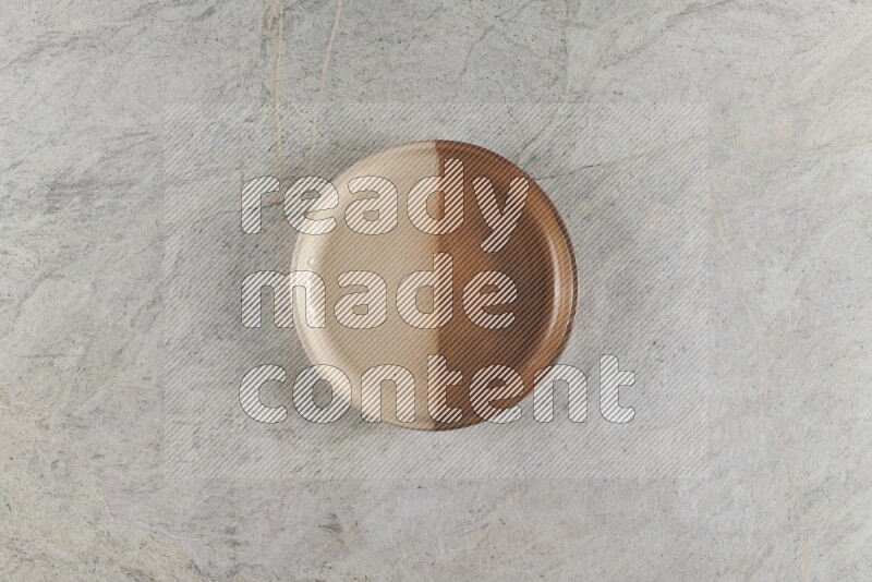 A multicolored pottery oven bowl on grey marble background