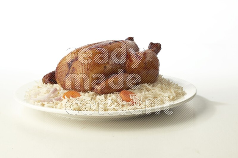 white  basmati Rice with  whole roasted chicken  on a white rounded plate direct on white background