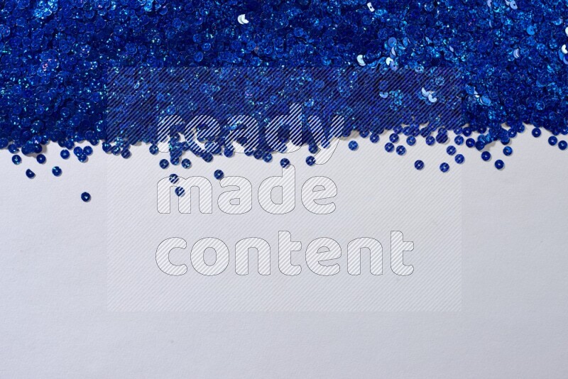 Multicolored flat sequins on grey background