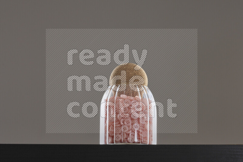 Buttons in a glass jar on black background