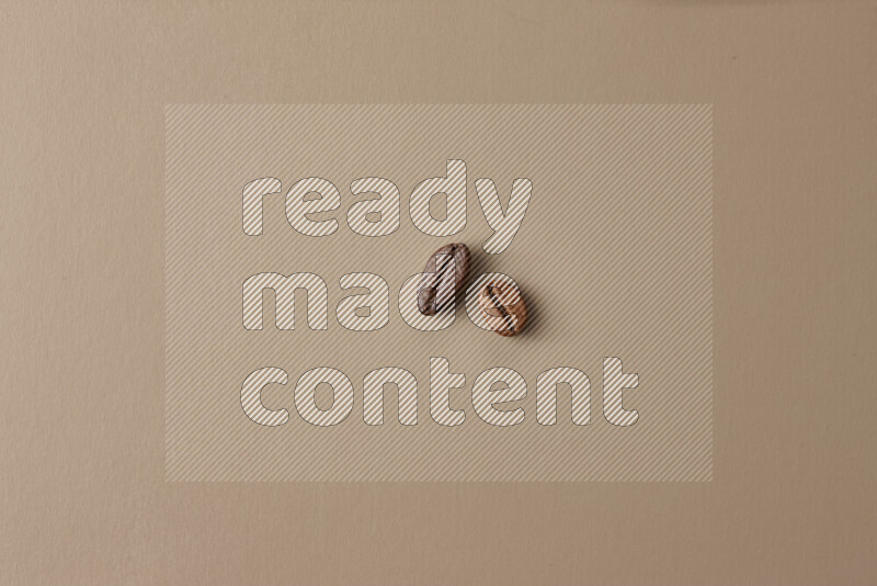 Roasted coffee beans on beige background