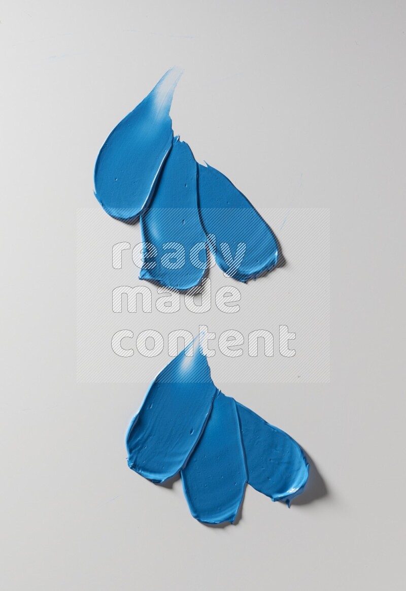 Blue painting knife strokes on white background