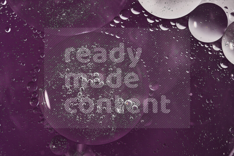Close-ups of abstract oil bubbles on water surface in shades of white and purple