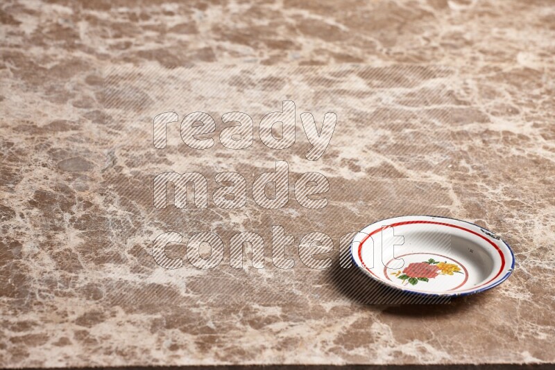 A vintage metal plate on beige marble background