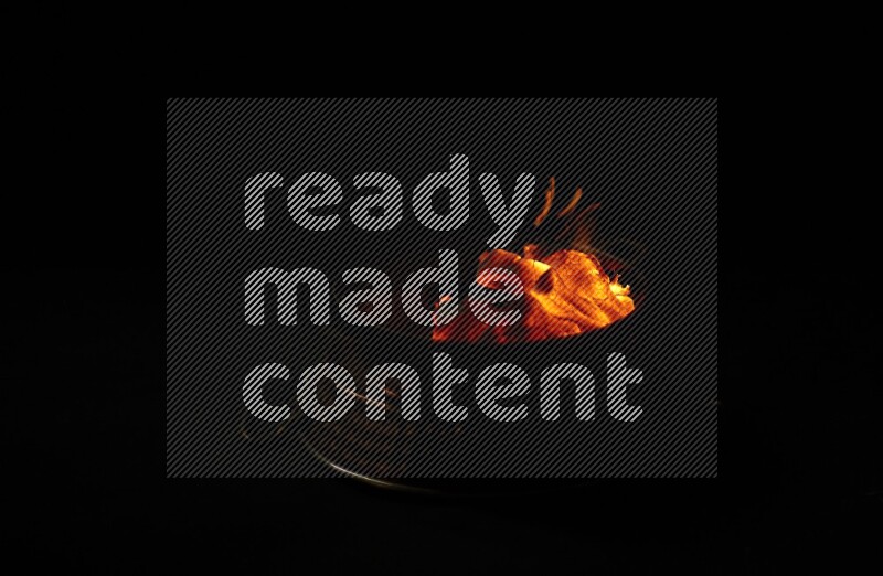 Coal cubes on fire in metal pan