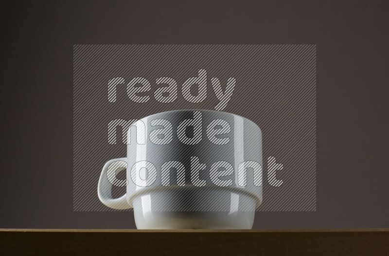 Low angle shot of a white cup on grey background