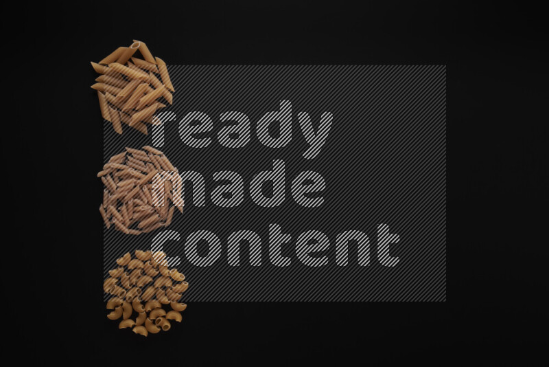 Different pasta types in 3 bunches on black background