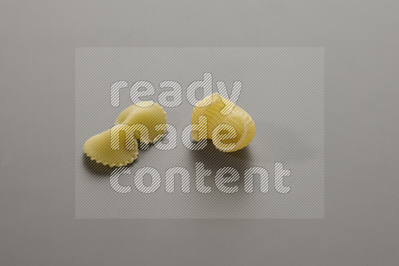 Fiocchi pasta with other types of pasta on grey background