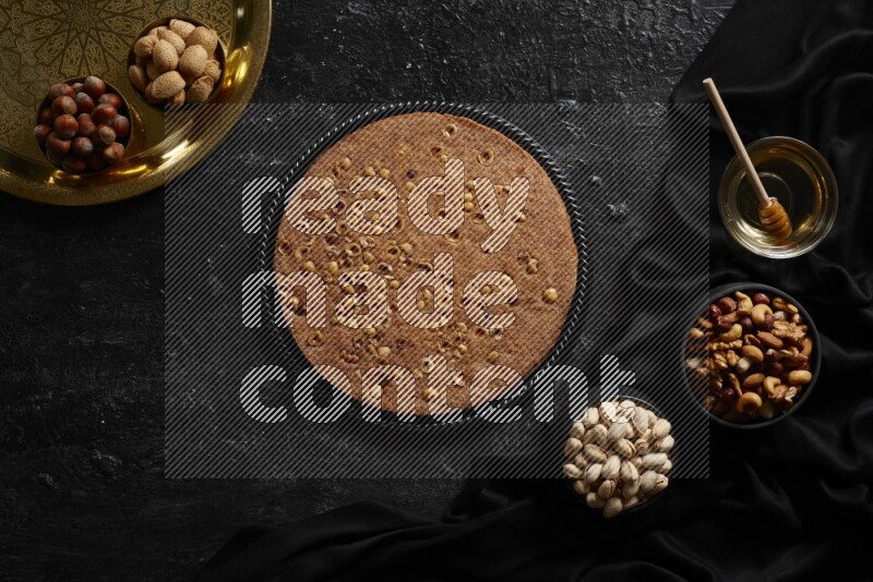 Basbousa with nuts and honey in a dark setup
