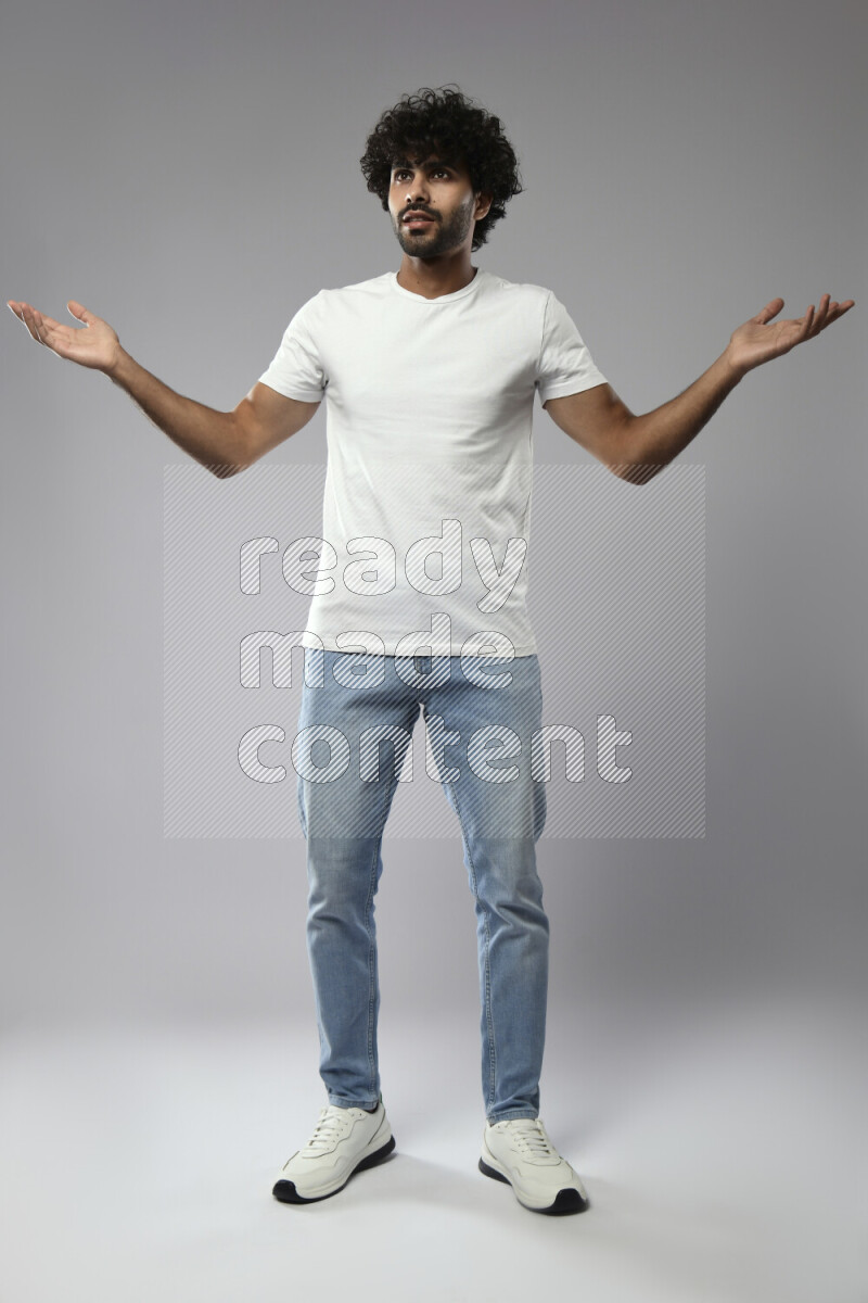 A man wearing casual standing and making a hand gesture on white background