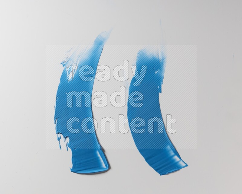 Blue curved painting knife strokes on white background