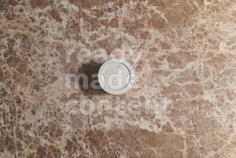 A pottery cup on beige marble background