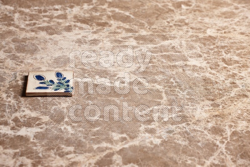 A decorative coaster on beige marble background
