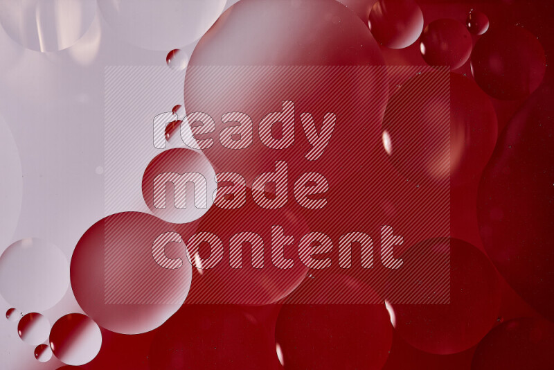 Close-ups of abstract oil bubbles on water surface in shades of white and red