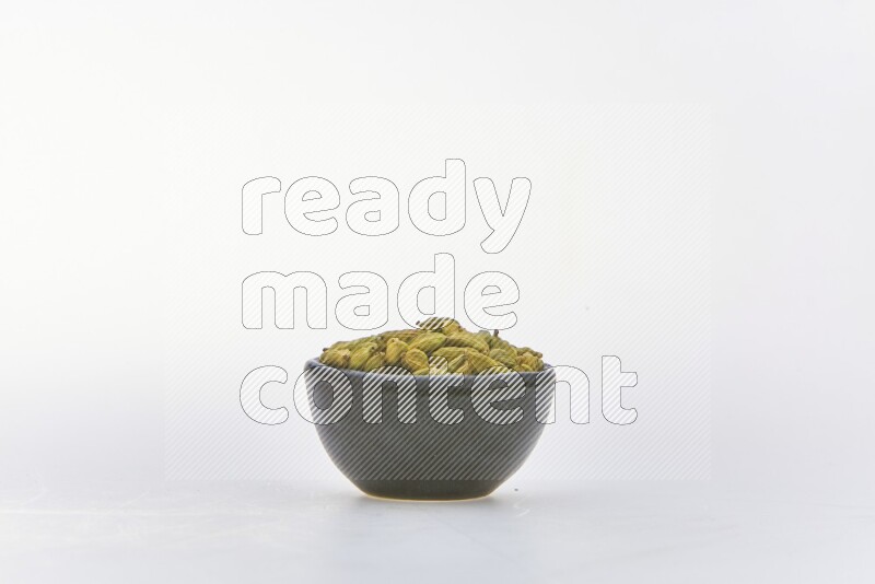 Cardamon in a container on white background
