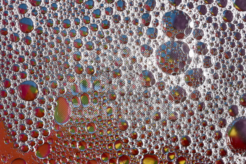 Close-ups of abstract soap bubbles and water droplets on multicolored background