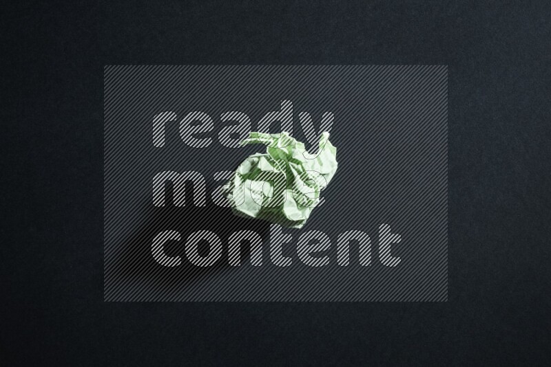 Green paper sheet on black background