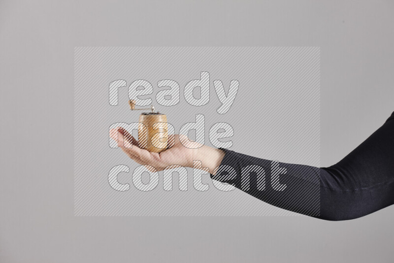 A woman in black abaya holding different wooden essentials in different positions