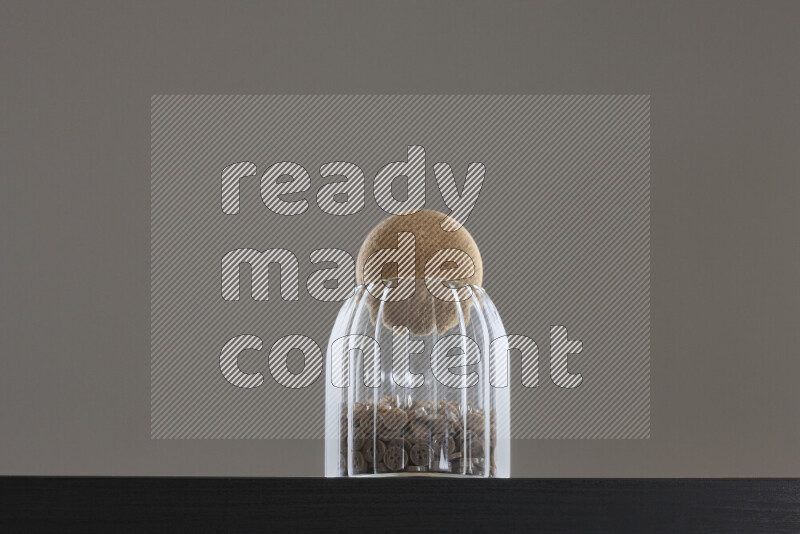 Buttons in a glass jar on black background