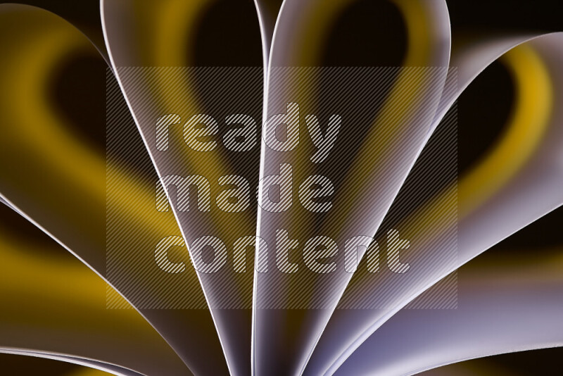 An abstract art piece displaying smooth curves in white and yellow gradients created by colored light