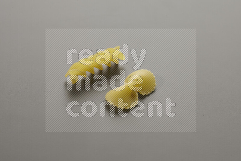 Fiocchi pasta with other types of pasta on grey background