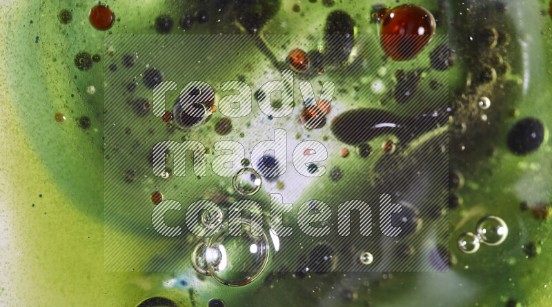 Close-ups of abstract red, green and blue watercolor drops on oil Surface on green background