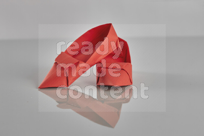 Origami shoes on grey background