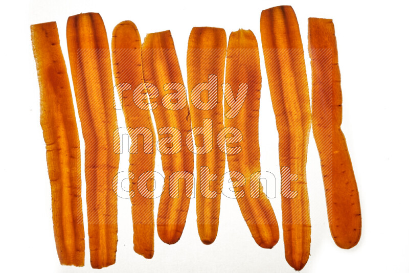 Carrots slices on illuminated white background