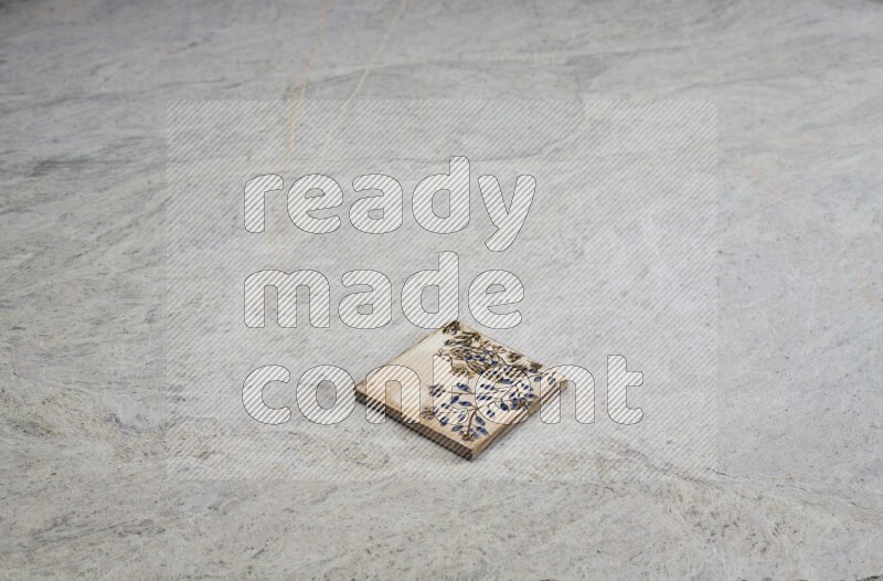 Top view shot of a pottery coaster\ tile on beige marble flooring