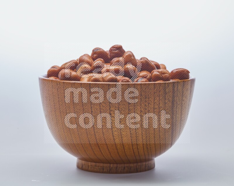 Close up shot of cooked fava beans (foul) in a container on white background