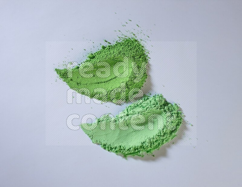 Green powder smears on white background