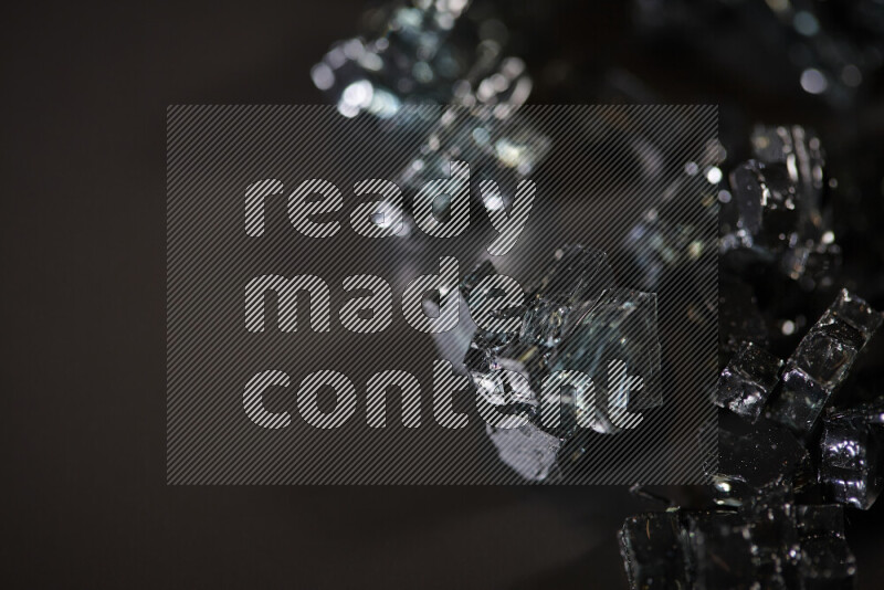 قطع زجاج سوداء شفافة متناثرة على خلفية سوداء