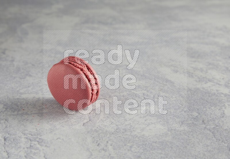 45º Shot of Pink Raspberry macaron on white  marble background
